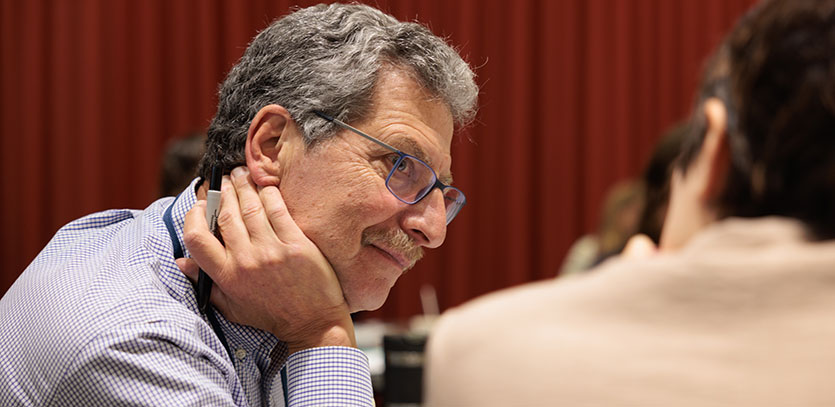 Workshop participants chat before a presentation.