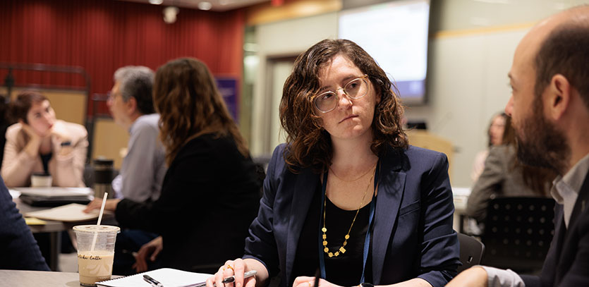 Workshop participants chat before a presentation.